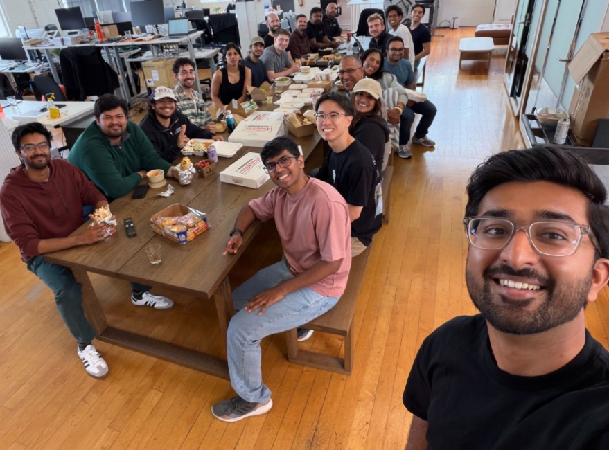 The Foundry team gathered around a long table in their workspace.